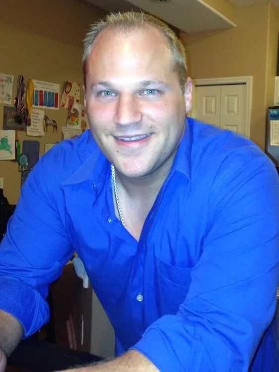 Jacob early in his career, at a desk in a blue shirt